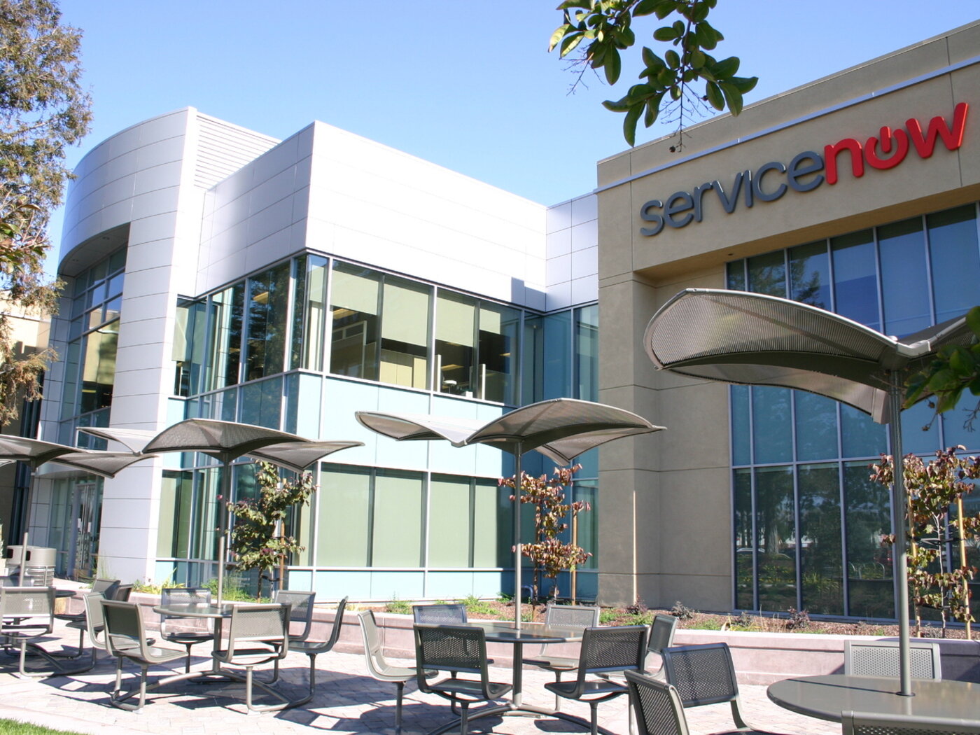 ServiceNow's headquarters building in Santa Clara, California, with the company's sign above the entrance.
